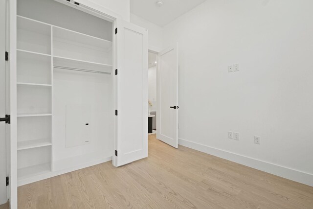 unfurnished bedroom featuring a closet and light hardwood / wood-style flooring