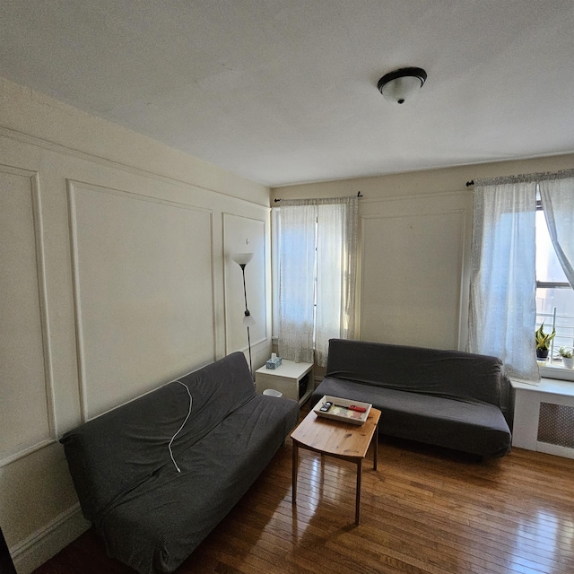 living room featuring hardwood / wood-style flooring and radiator heating unit