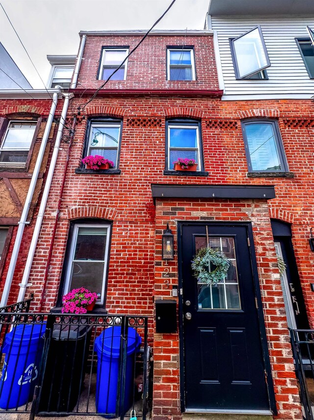 123 Willow Ter, Hoboken, NJ 07030 - view of exterior entry featuring brick siding and fence