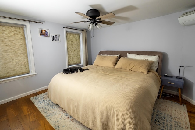 123 Willow Ter, Hoboken, NJ 07030 - bedroom with wood finished floors, an AC wall unit, and baseboards
