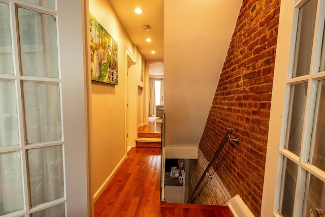 123 Willow Ter, Hoboken, NJ 07030 - hallway featuring wood finished floors, recessed lighting, brick wall, and baseboards