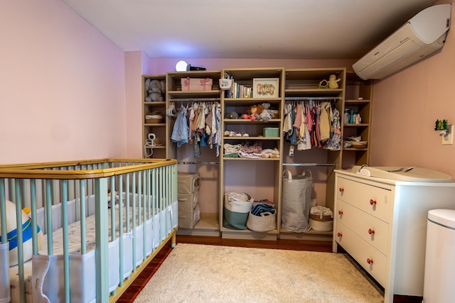 123 Willow Ter, Hoboken, NJ 07030 - bedroom with a wall unit AC and wood finished floors