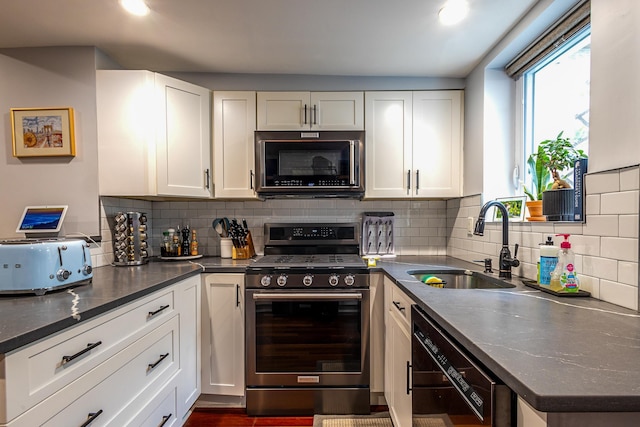 123 Willow Ter, Hoboken, NJ 07030 - kitchen featuring stainless steel gas stove, black dishwasher, a sink, and white cabinetry