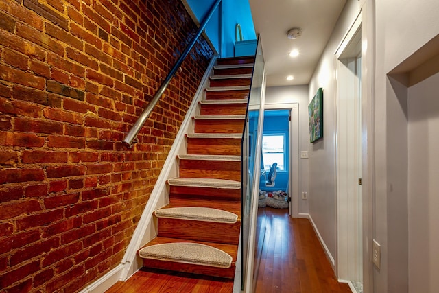 123 Willow Ter, Hoboken, NJ 07030 - stairway featuring wood-type flooring, baseboards, and brick wall