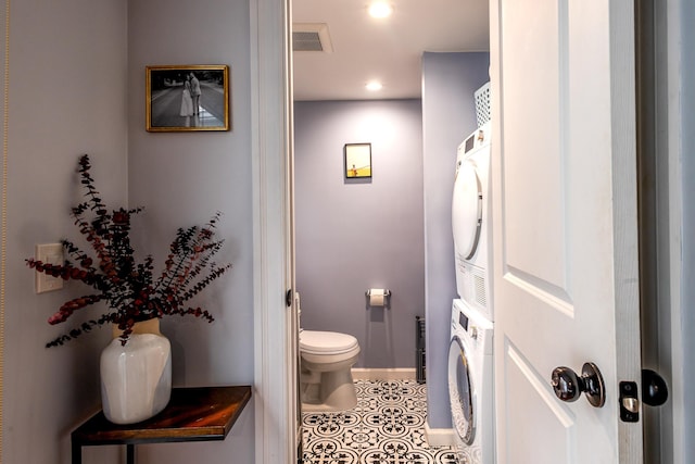 123 Willow Ter, Hoboken, NJ 07030 - bathroom featuring estacked washer and dryer, toilet, tile patterned flooring, recessed lighting, and baseboards