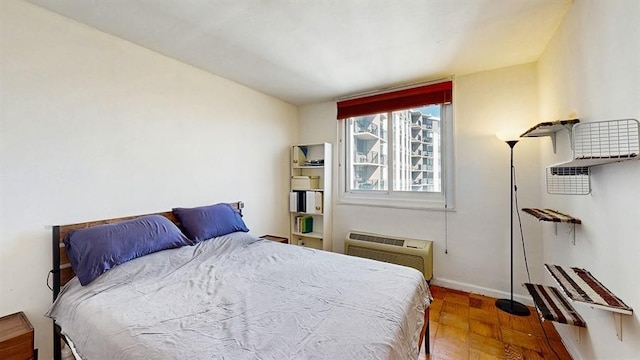 100 Manhattan Ave Unit 1912, Union City, NJ 07087 - bedroom featuring baseboards, a wall unit AC, and wood finished floors