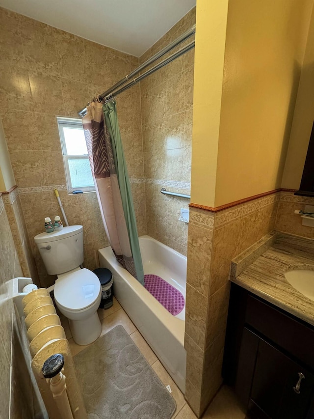 full bathroom featuring shower / bath combo, tile patterned floors, toilet, vanity, and tile walls