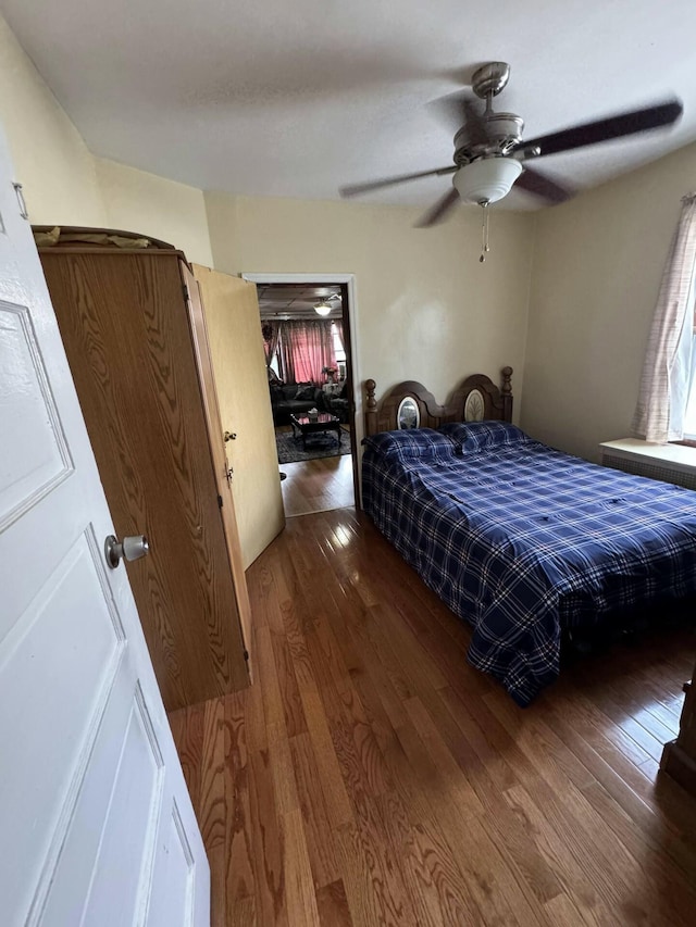 bedroom featuring wood-type flooring and ceiling fan