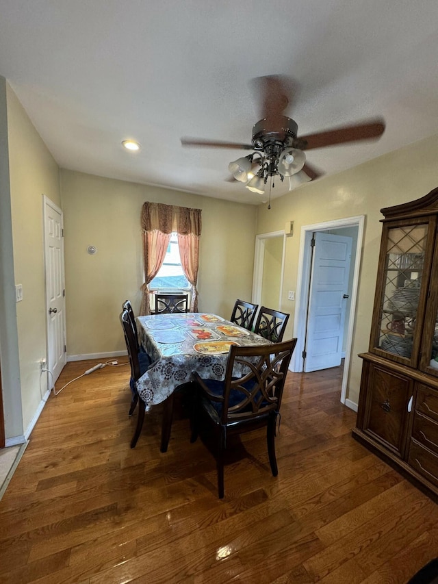 dining space featuring ceiling fan and dark hardwood / wood-style floors