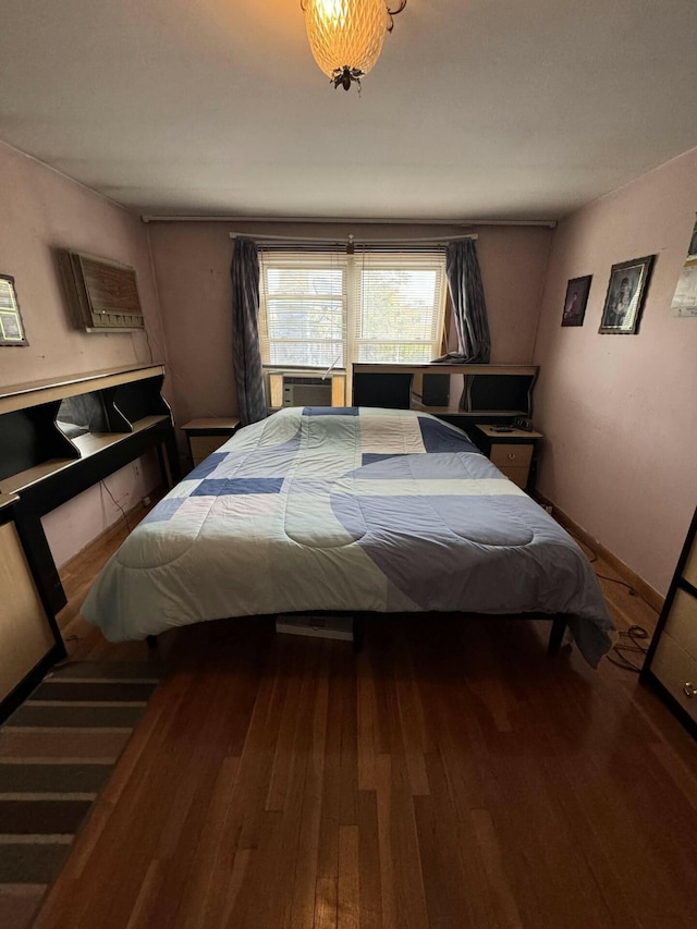 bedroom with hardwood / wood-style floors and cooling unit