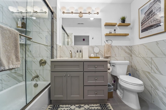936 Pavonia Ave # 3A, Jersey City, NJ 07306 - full bathroom with shower / bath combination with glass door, visible vents, toilet, tile walls, and vanity