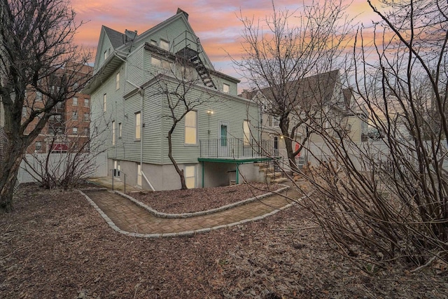 property exterior at dusk with a chimney