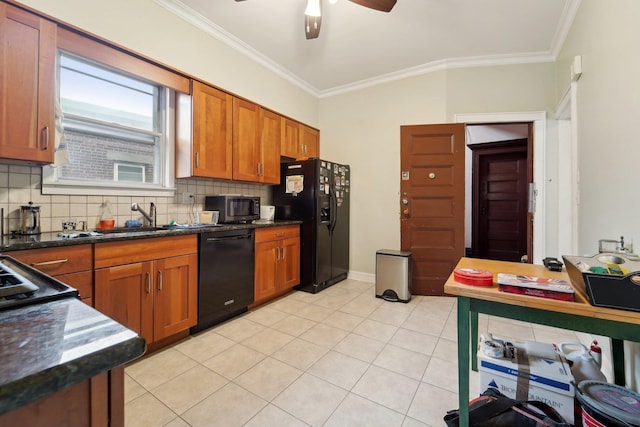 kitchen with tasteful backsplash, brown cabinets, a sink, black appliances, and ornamental molding