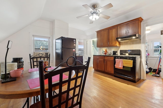 kitchen featuring backsplash, a ceiling fan, light wood-type flooring, black appliances, and under cabinet range hood