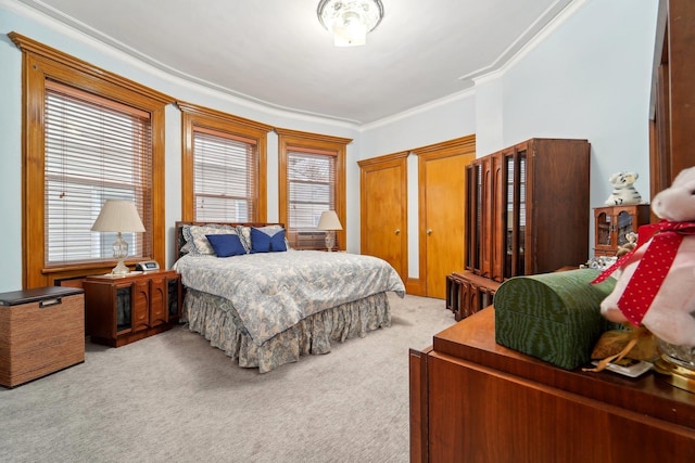 carpeted bedroom featuring crown molding and multiple windows