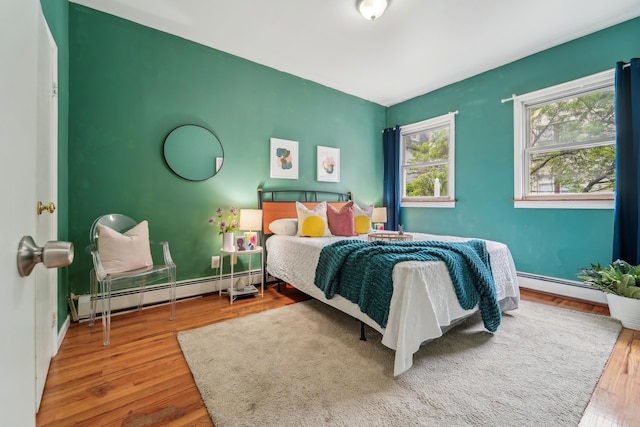 37 47th St, Weehawken, NJ 07086 - bedroom featuring a baseboard radiator, wood finished floors, and baseboards