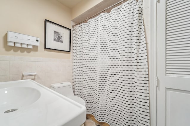 37 47th St, Weehawken, NJ 07086 - full bath featuring tile walls, a shower with shower curtain, a sink, wainscoting, and toilet