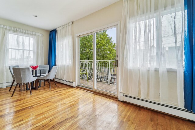 37 47th St, Weehawken, NJ 07086 - doorway to outside with a baseboard radiator and wood finished floors
