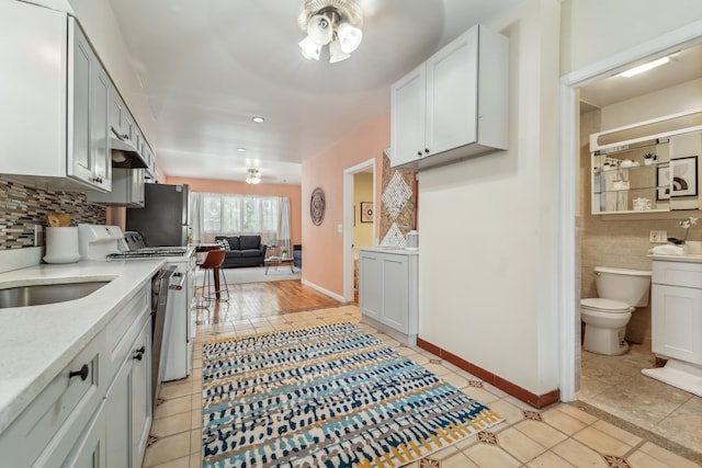 37 47th St, Weehawken, NJ 07086 - kitchen featuring range with gas stovetop, a ceiling fan, freestanding refrigerator, light tile patterned floors, and recessed lighting
