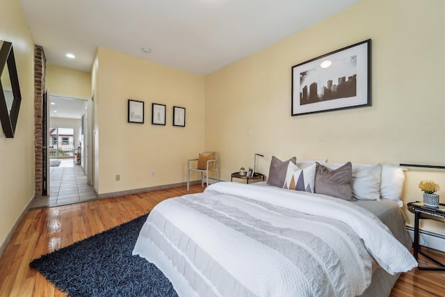 37 47th St, Weehawken, NJ 07086 - bedroom featuring a baseboard radiator, wood finished floors, baseboards, and recessed lighting