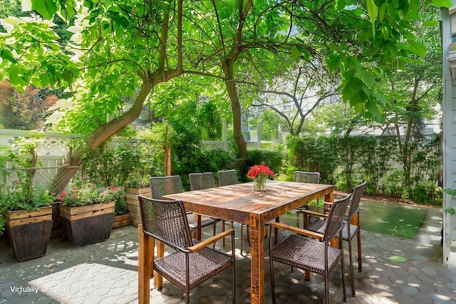view of patio with a fenced backyard and outdoor dining area