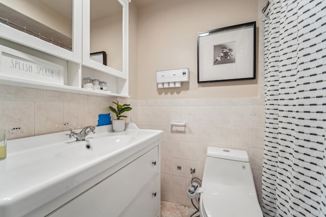 37 47th St, Weehawken, NJ 07086 - bathroom with tile walls, toilet, vanity, and wainscoting