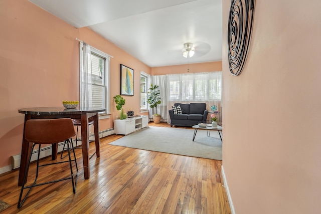 37 47th St, Weehawken, NJ 07086 - living area with light wood-type flooring, a ceiling fan, baseboard heating, and baseboards