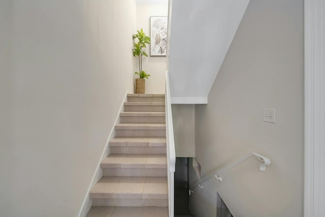 staircase with baseboards and tile patterned flooring