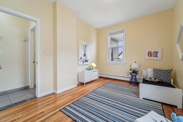 37 47th St, Weehawken, NJ 07086 - living area with a baseboard heating unit, wood finished floors, and baseboards
