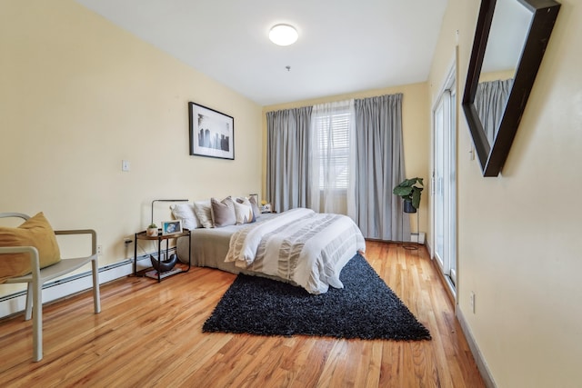 37 47th St, Weehawken, NJ 07086 - bedroom with light wood-style floors, a baseboard radiator, and baseboards