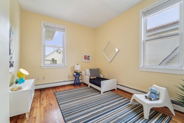 37 47th St, Weehawken, NJ 07086 - living area with healthy amount of natural light, baseboard heating, and wood finished floors