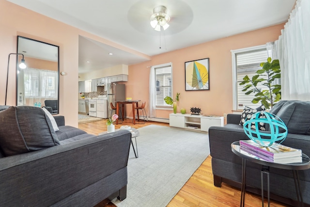 37 47th St, Weehawken, NJ 07086 - living area featuring a ceiling fan, light wood-style floors, and a baseboard heating unit