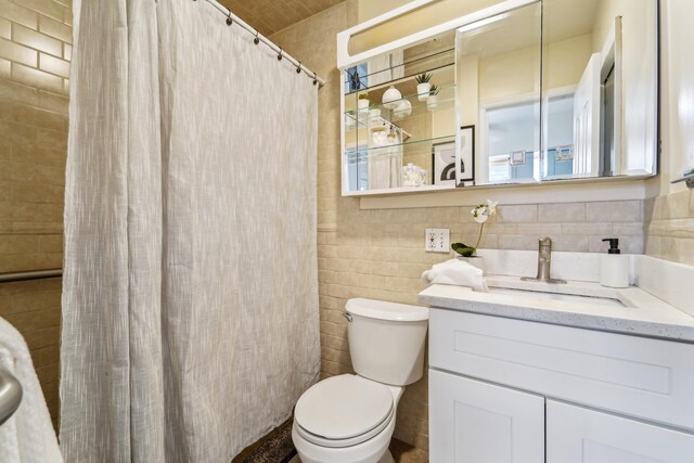 37 47th St, Weehawken, NJ 07086 - bathroom with tile walls, toilet, vanity, and curtained shower