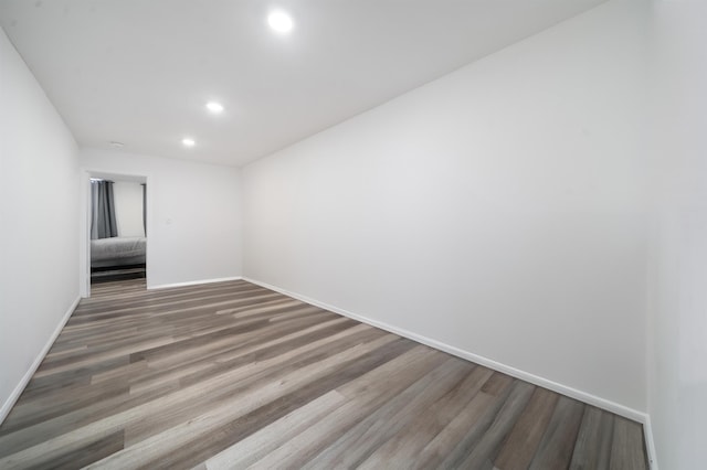 empty room with hardwood / wood-style flooring