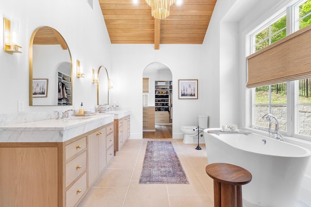 150 Mountain Ave, Pequannock Township, NJ 07444 - bathroom with wood ceiling, a freestanding tub, tile patterned flooring, vanity, and a walk in closet