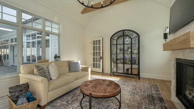 150 Mountain Ave, Pequannock Township, NJ 07444 - living room featuring a stone fireplace, wood finished floors, high vaulted ceiling, a chandelier, and baseboards