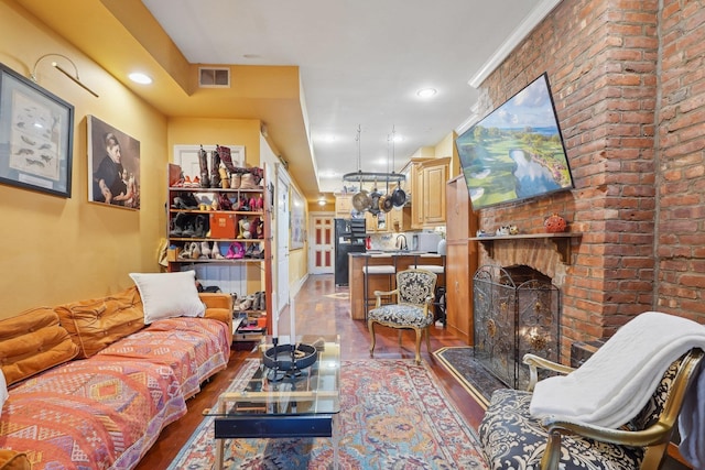 living room featuring a fireplace and sink