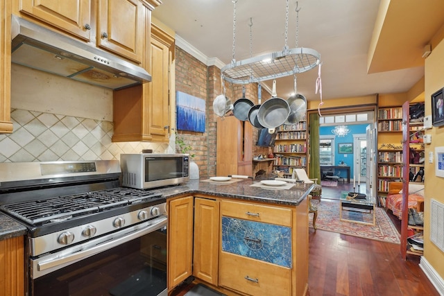 kitchen with dark stone countertops, stainless steel appliances, kitchen peninsula, dark wood-type flooring, and tasteful backsplash