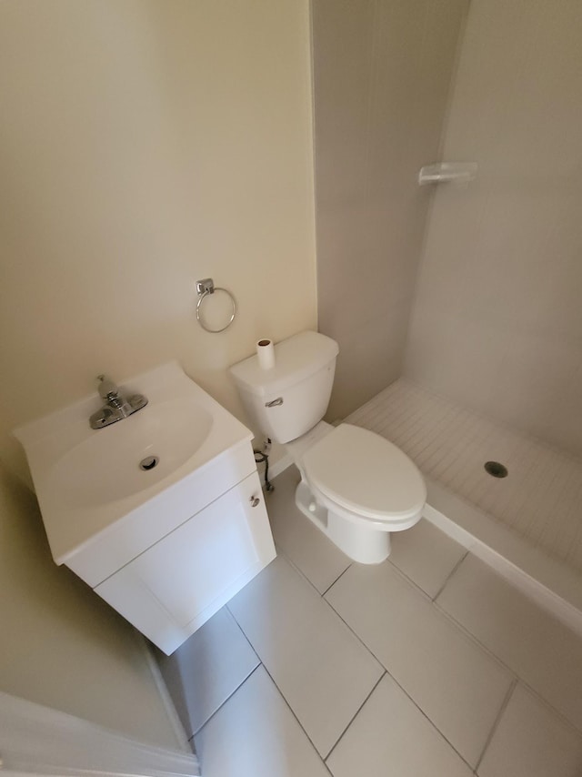 bathroom with vanity, toilet, a stall shower, and tile patterned flooring