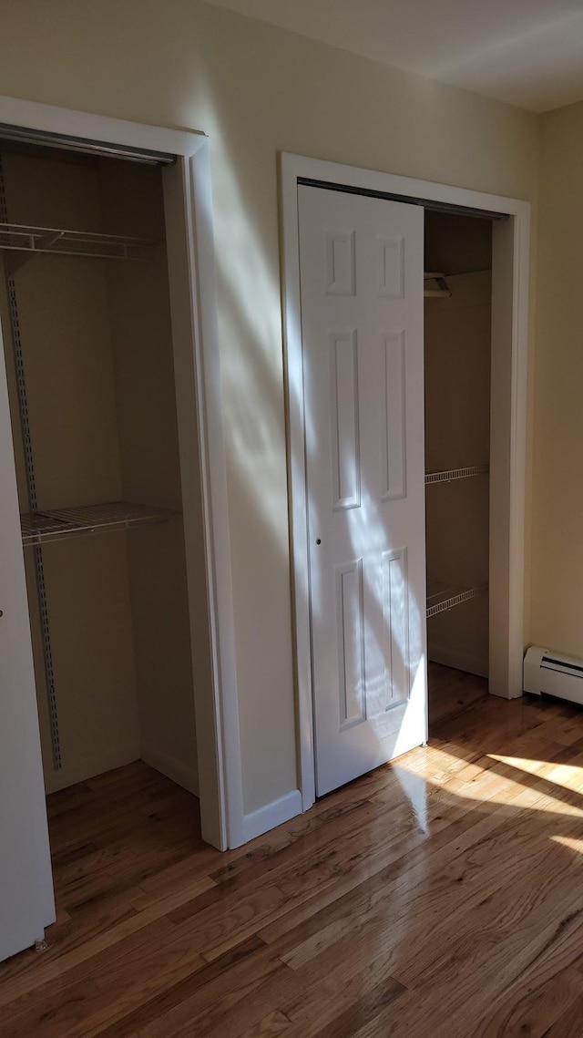 unfurnished bedroom featuring a closet and wood finished floors