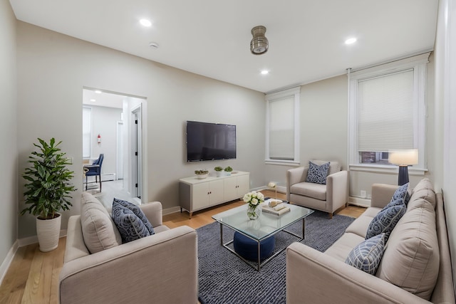 living area featuring light wood-type flooring, baseboards, and recessed lighting