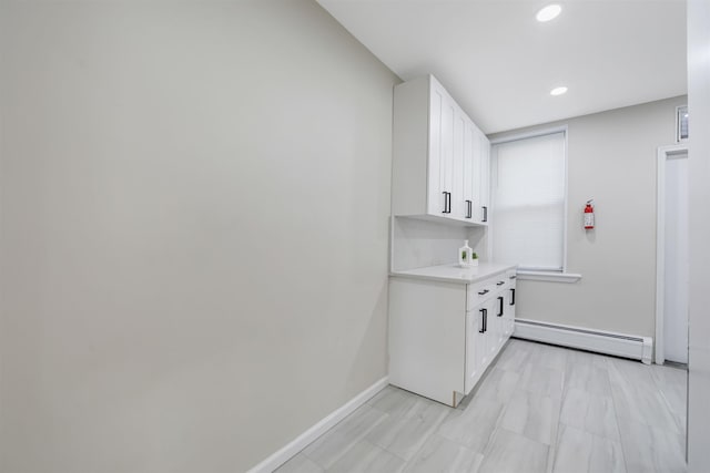 interior space with baseboard heating, recessed lighting, and baseboards