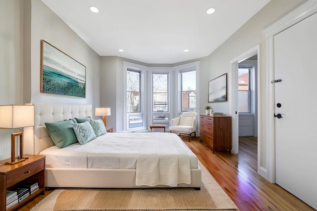 bedroom with wood finished floors and recessed lighting