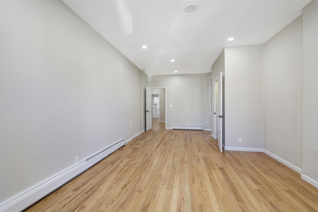 unfurnished room featuring recessed lighting, baseboards, light wood finished floors, and baseboard heating