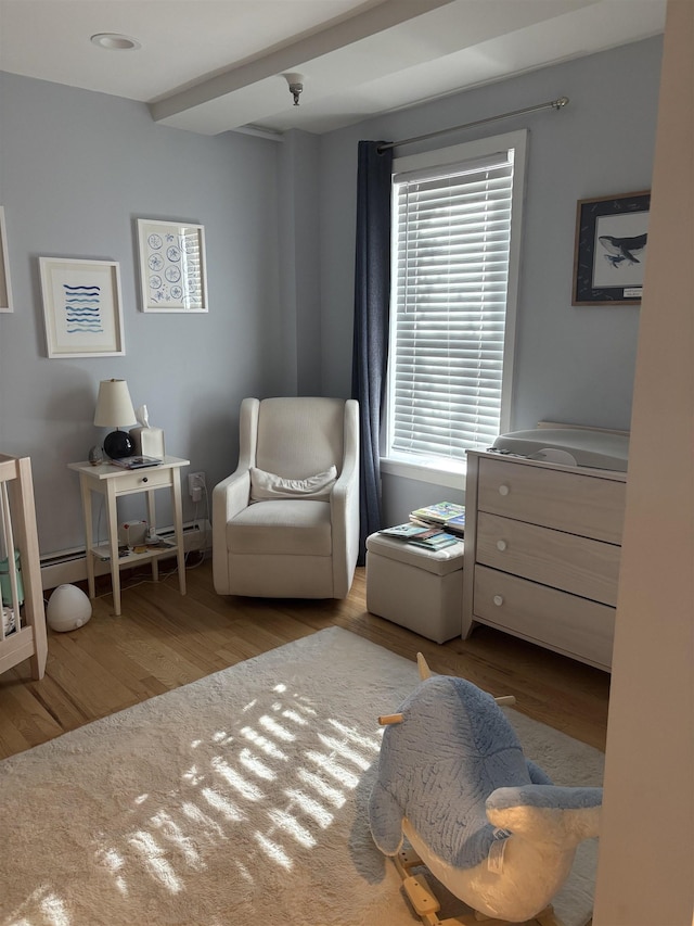 sitting room with plenty of natural light and light hardwood / wood-style floors