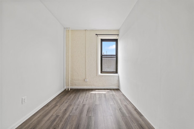 unfurnished room with wood finished floors and baseboards
