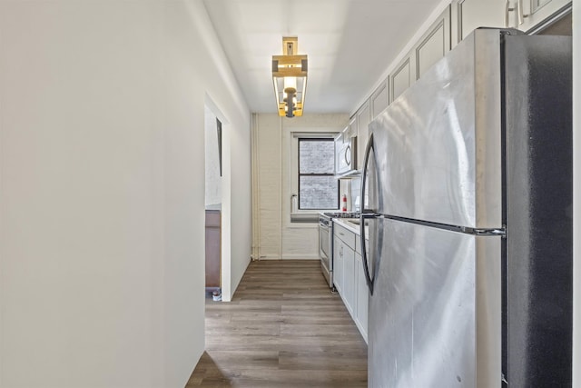 kitchen featuring stainless steel appliances and wood finished floors
