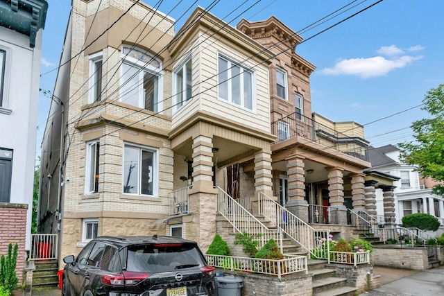 123 Shippen St, Weehawken, NJ 07086 - view of front of property featuring a porch, brick siding, and stairway