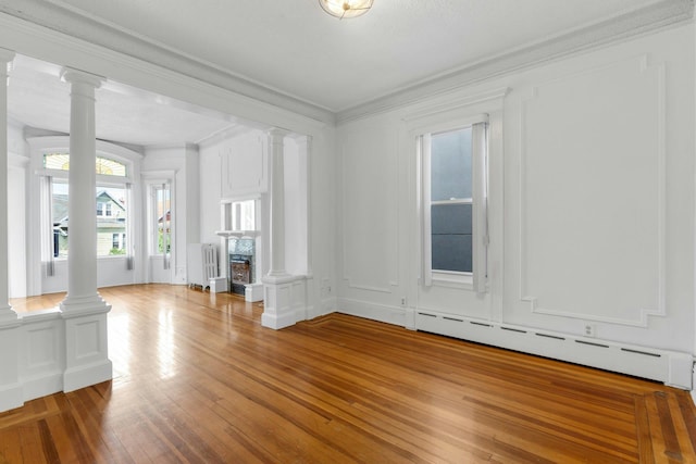 123 Shippen St, Weehawken, NJ 07086 - unfurnished living room featuring decorative columns, radiator heating unit, baseboard heating, wood-type flooring, and ornamental molding