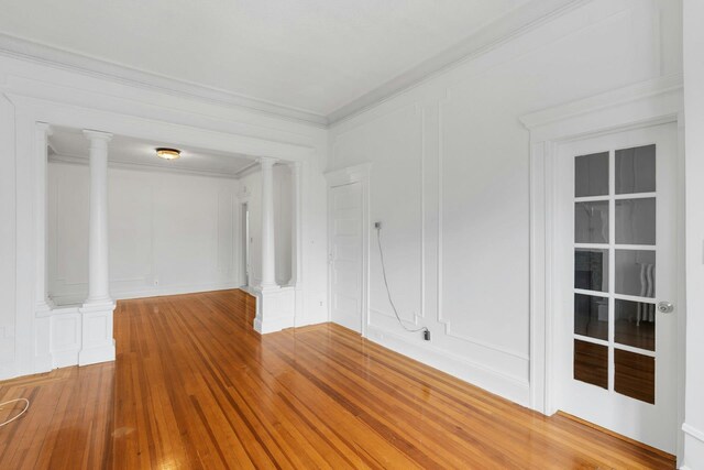 123 Shippen St, Weehawken, NJ 07086 - spare room featuring a decorative wall, decorative columns, wood finished floors, and ornamental molding